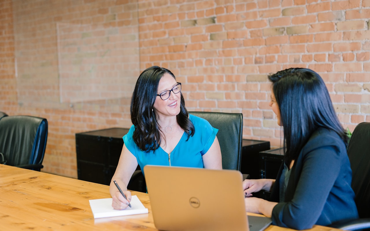 Financial advisor meeting with a client at a table