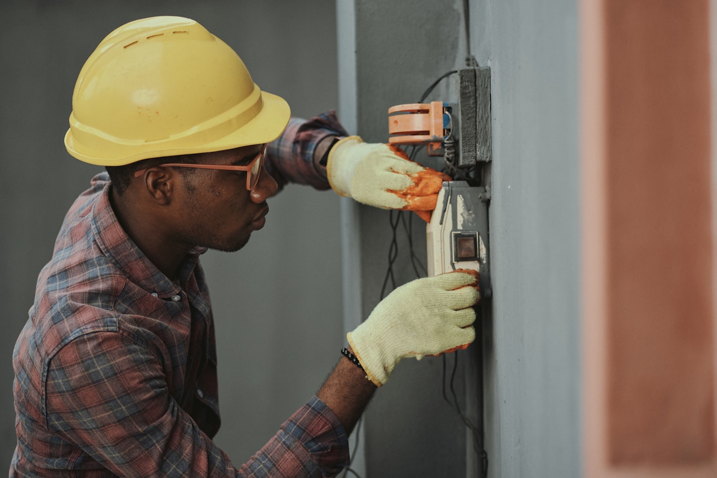 Home services electrician working on an outdoor electrical box