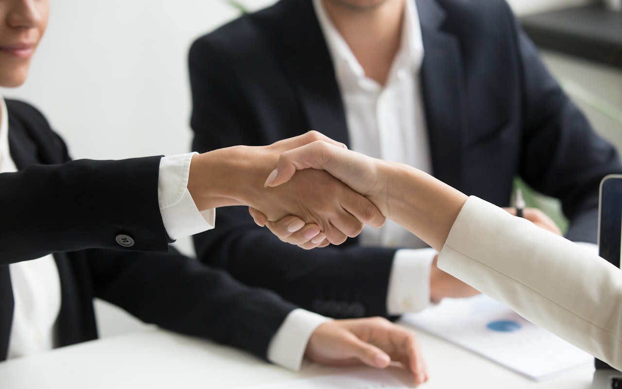 Attorney shaking hands with a new client after a booked consultation