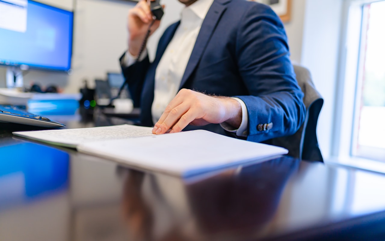 Attorney taking a new-client call at their office desk