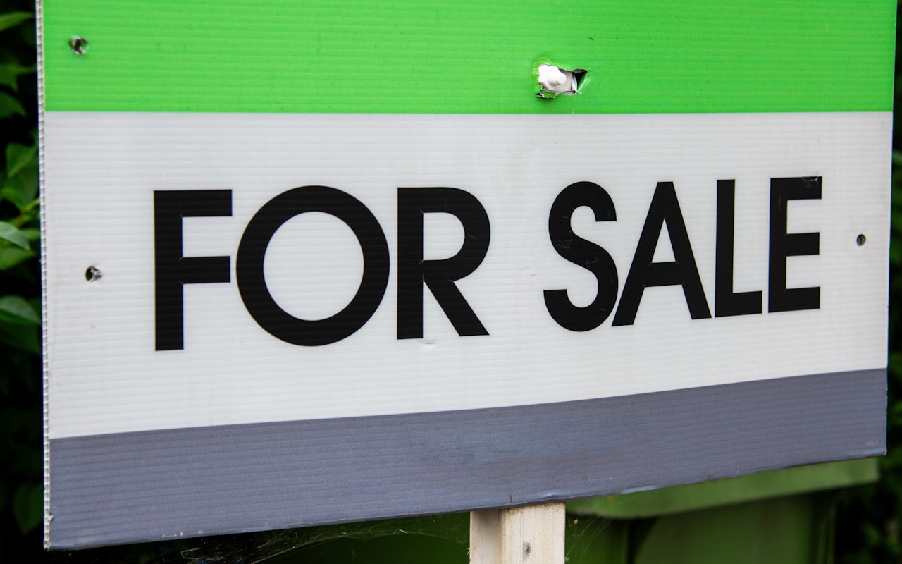 A for-sale sign outside a listed home