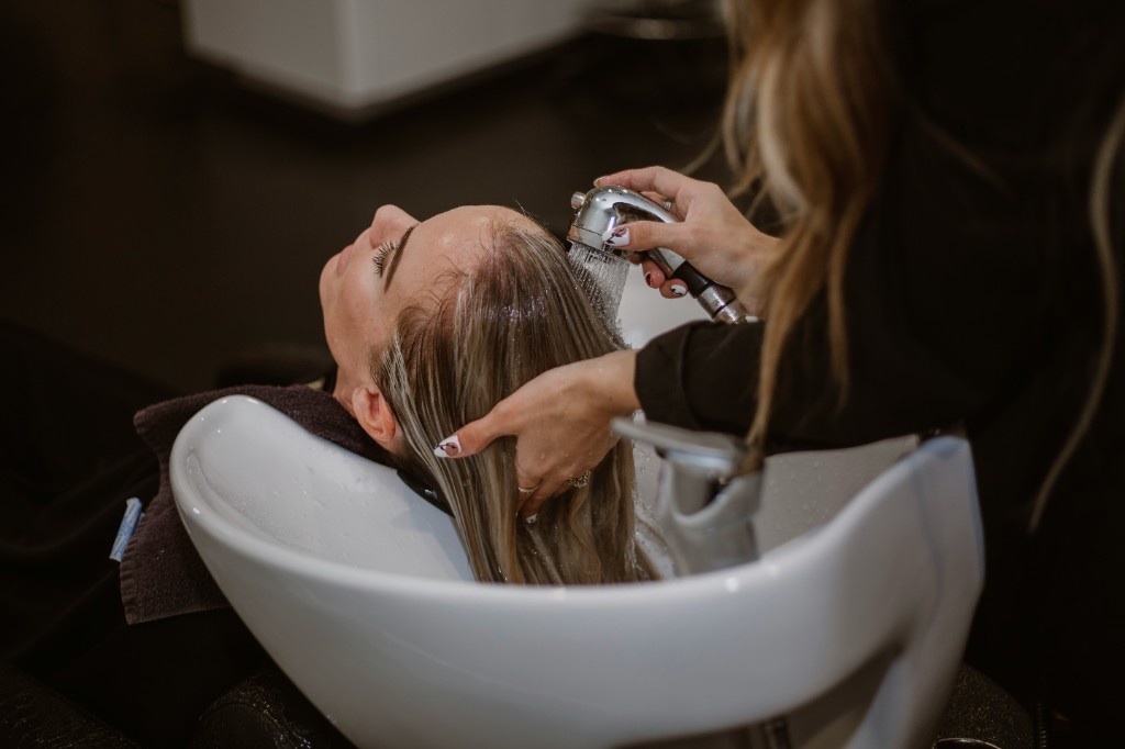 Client getting a hair wash at a salon after booking