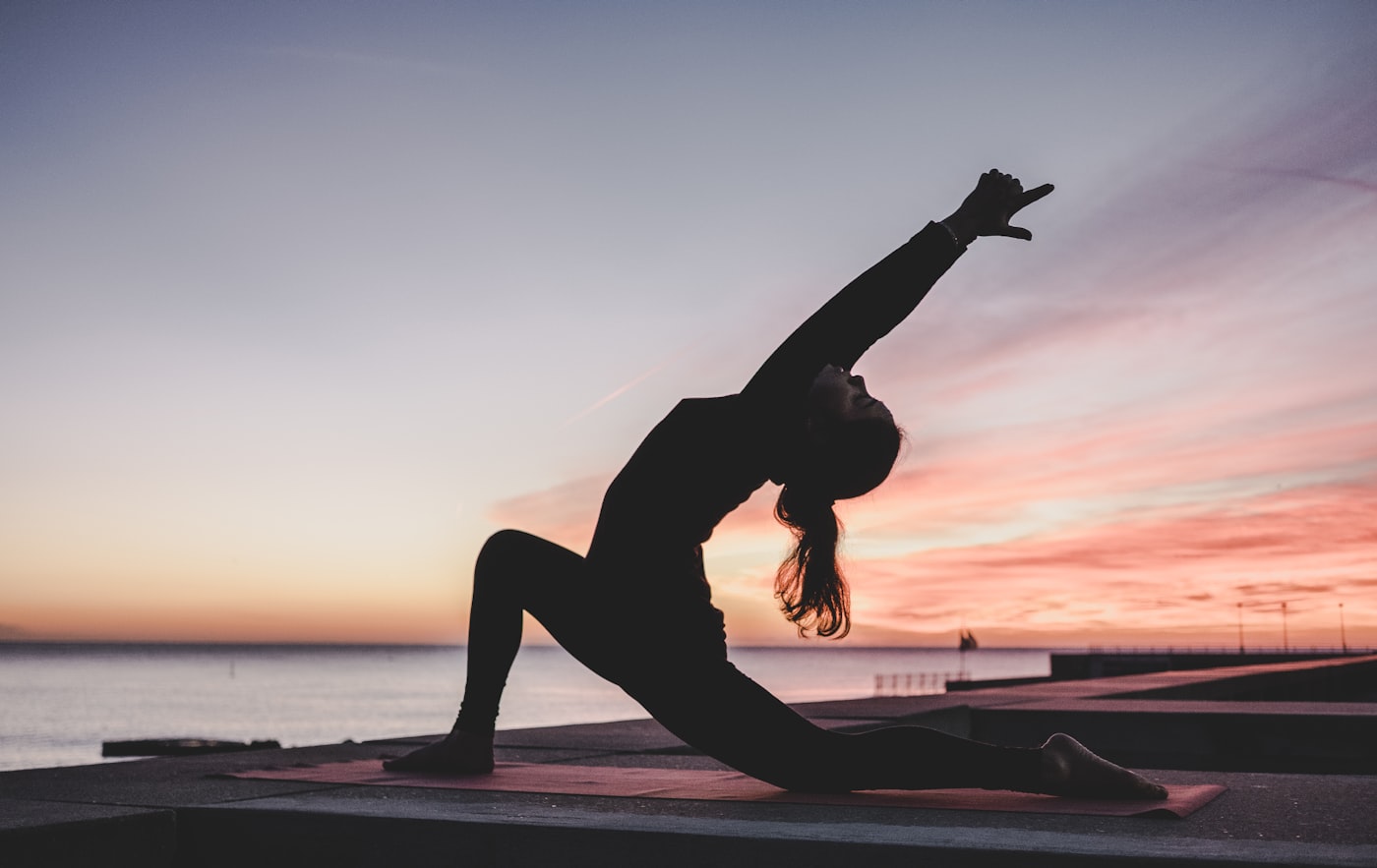 Yoga practitioner in a sunrise pose ready for class booking